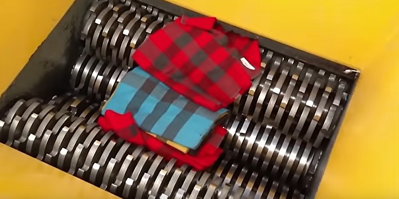 Clothing items being shredded as part of our UK secure textile and uniform destruction service