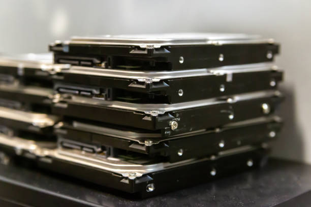 Close-up of stacked hard drives ready for secure data destruction and recycling.