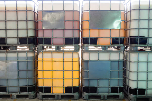 Large IBC containers filled with leftover or waste paint prepared for recycling or disposal.