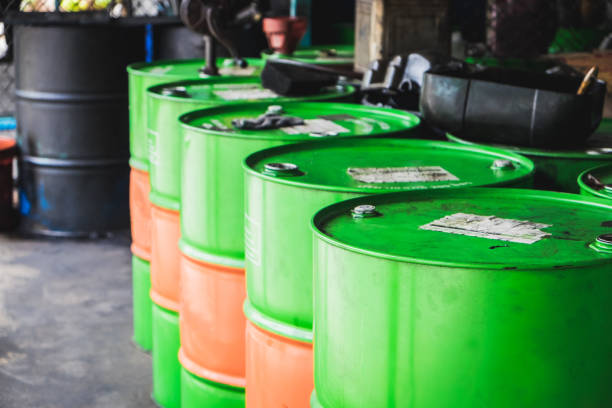 Large industrial oil barrels arranged for safe recycling and disposal.