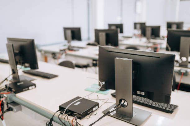Room filled with computers and monitors prepared for secure IT asset disposition and recycling.