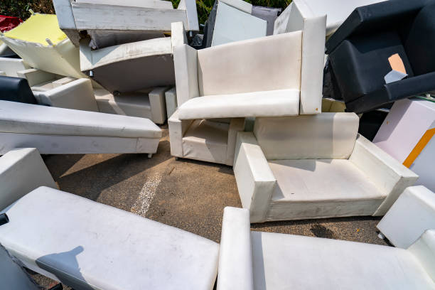 Old sofas ready for collection and recycling by Pops Recycling in the UK