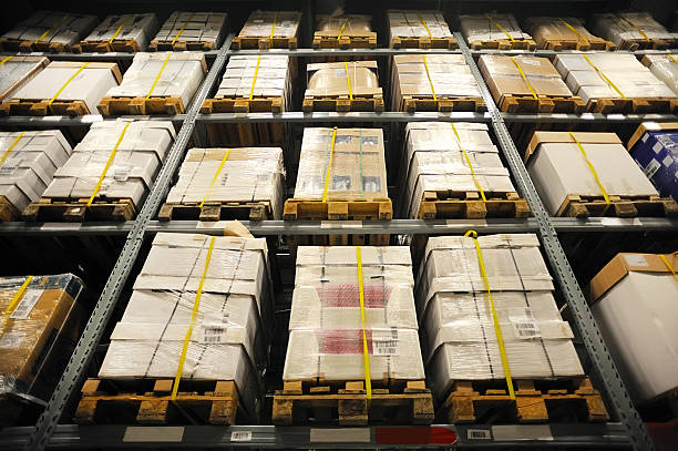 Old pallets on warehouse racking with WEEE waste ready for disposal and rebate collection in the UK